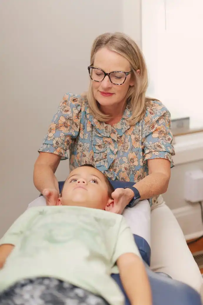 Dr. Cindy Frazier adjusting a child