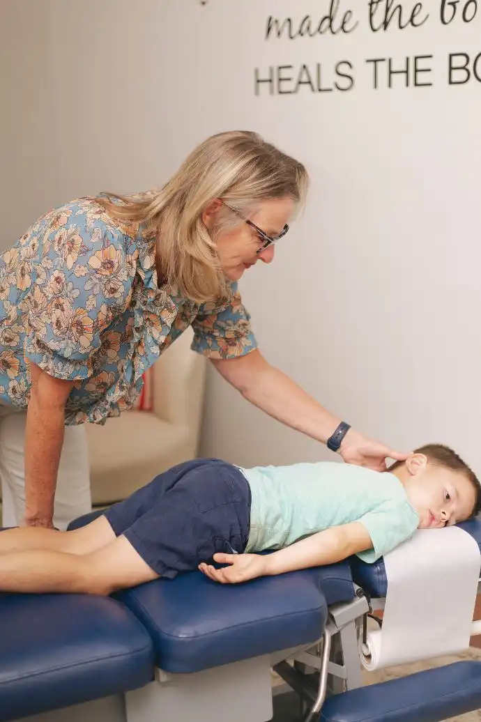Dr. Cindy Frazier adjusting young boy