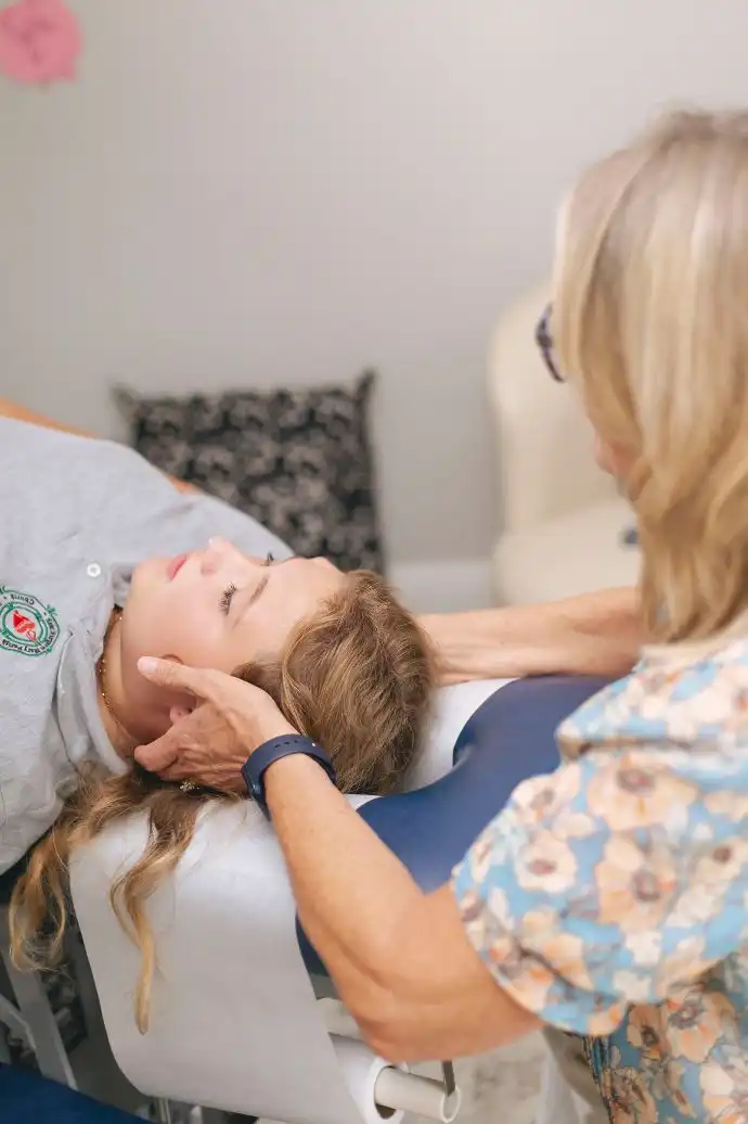 Dr. Cindy adjusting young girl